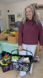 A woman holds a shopping basket